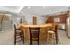 L-shaped kitchen island with barstools and brick accent wall at 1218 Se 11Th St, Ocala, FL 34471
