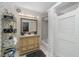 Clean bathroom with vintage-style vanity and a shower/tub combo at 1218 Se 11Th St, Ocala, FL 34471