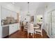 Bright dining area with hardwood floors, chandelier and access to the kitchen at 1218 Se 11Th St, Ocala, FL 34471
