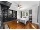 Bedroom with built-in shelving, hardwood floors, and a metal bed frame at 1218 Se 11Th St, Ocala, FL 34471