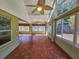 Spacious sunroom with tiled floors and many windows at 13166 Se 86Th Cir, Summerfield, FL 34491