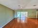 Bright living room with hardwood floors and sliding glass doors leading to a patio at 13166 Se 86Th Cir, Summerfield, FL 34491