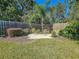 Landscaped backyard with palm tree and sitting area at 13166 Se 86Th Cir, Summerfield, FL 34491