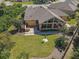 Aerial view of a house with a large backyard, sunroom, and patio at 13166 Se 86Th Cir, Summerfield, FL 34491