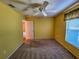 Bright bedroom with carpet flooring, ceiling fan, and window at 13166 Se 86Th Cir, Summerfield, FL 34491