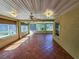 Sunroom with tile floors and ceiling fan, access to backyard at 13166 Se 86Th Cir, Summerfield, FL 34491