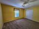 Bright bedroom with carpet flooring, ceiling fan, and window at 13166 Se 86Th Cir, Summerfield, FL 34491