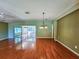 Bright dining room with hardwood floors and view to the sunroom at 13166 Se 86Th Cir, Summerfield, FL 34491