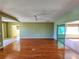 Spacious living room featuring hardwood floors and access to a sunroom at 13166 Se 86Th Cir, Summerfield, FL 34491