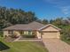 House exterior showcasing a front yard and driveway at 13166 Se 86Th Cir, Summerfield, FL 34491