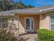 Front entry with a glass door and brick walkway at 13166 Se 86Th Cir, Summerfield, FL 34491