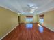 Hardwood floor living room with multiple windows and ceiling fan at 13166 Se 86Th Cir, Summerfield, FL 34491