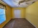 Bright bedroom with carpet flooring, ceiling fan, and window at 13166 Se 86Th Cir, Summerfield, FL 34491