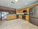 Kitchen features wood cabinets, stainless steel appliances, and ample counter space at 13166 Se 86Th Cir, Summerfield, FL 34491