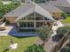 Aerial view showcasing the house's sunroom and landscaped backyard at 13166 Se 86Th Cir, Summerfield, FL 34491