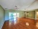 Bright living room with hardwood floors and sliding glass doors leading to a patio at 13166 Se 86Th Cir, Summerfield, FL 34491