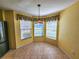 Bright breakfast nook with tiled floor and three windows at 13166 Se 86Th Cir, Summerfield, FL 34491