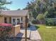 Backyard with a paved patio, wooden fence, and mature trees at 13166 Se 86Th Cir, Summerfield, FL 34491