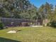 Backyard oasis with a grassy lawn, wooden fence, and bird feeders at 13166 Se 86Th Cir, Summerfield, FL 34491
