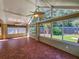 Bright sunroom with tiled floor, ceiling fan, and view of backyard at 13166 Se 86Th Cir, Summerfield, FL 34491