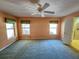 Well-lit bedroom featuring carpet, ceiling fan, and multiple windows at 13166 Se 86Th Cir, Summerfield, FL 34491