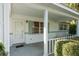 White front porch with a door, windows and hedges at 8620 Sw 94Th St # G, Ocala, FL 34481