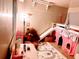 Fun ' bedroom featuring a bunk bed with slide and play area at 34828 1St Ave, Leesburg, FL 34788