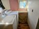 Laundry room with washer, dryer, and extra storage at 34828 1St Ave, Leesburg, FL 34788
