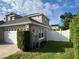 Side view of house with white fence and landscaping at 3403 Gatlin Place Cir, Orlando, FL 32812