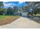 House with a long driveway and a green lawn at 19662 Sw Marine Blvd, Dunnellon, FL 34431