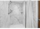 Updated shower with marble-look walls and a white shower curtain at 2810 Se 8Th St, Ocala, FL 34471