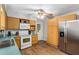 Kitchen with wood cabinets, white appliances, and teal countertops at 2810 Se 8Th St, Ocala, FL 34471