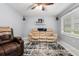 Living room with beige sofa, recliner, and ceiling fan at 2810 Se 8Th St, Ocala, FL 34471