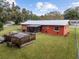Spacious backyard with deck, screened-in patio, and mature trees at 2810 Se 8Th St, Ocala, FL 34471