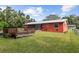 Red house exterior with a deck and a large backyard at 2810 Se 8Th St, Ocala, FL 34471