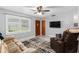 Bright living room with window, ceiling fan, and comfy seating at 2810 Se 8Th St, Ocala, FL 34471