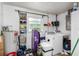 Laundry room with washer, dryer, storage shelves, and window at 2810 Se 8Th St, Ocala, FL 34471