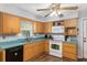 Kitchen boasts wood cabinets, white appliances & teal countertops at 2810 Se 8Th St, Ocala, FL 34471