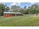 Red house with metal roof and fenced yard at 2810 Se 8Th St, Ocala, FL 34471