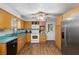 Kitchen features wood cabinets, white appliances, and teal countertops at 2810 Se 8Th St, Ocala, FL 34471