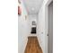 Long hallway with light walls, wood-look flooring, and access to other rooms at 2810 Se 8Th St, Ocala, FL 34471