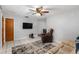 Living room features a ceiling fan, large TV, and comfortable seating at 2810 Se 8Th St, Ocala, FL 34471