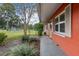 Side view of red house with walkway and landscaping at 2810 Se 8Th St, Ocala, FL 34471