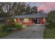 Red house with metal roof and carport at 2810 Se 8Th St, Ocala, FL 34471