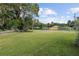 Large grassy front yard with mature trees at 2810 Se 8Th St, Ocala, FL 34471