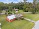Aerial view of a red brick ranch home with a metal roof and large backyard at 2810 Se 8Th St, Ocala, FL 34471
