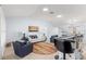 Spacious living room featuring a white couch and blue armchairs, complete with a colorful rug at 7290 Se 172Nd Legacy Ln, The Villages, FL 32162