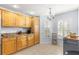 Kitchen boasts wood cabinets, granite counters, and light walls at 7290 Se 172Nd Legacy Ln, The Villages, FL 32162