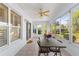 Relaxing screened porch with seating area and ceiling fan at 7290 Se 172Nd Legacy Ln, The Villages, FL 32162