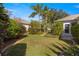Landscaped backyard with lush lawn and tropical plants at 7290 Se 172Nd Legacy Ln, The Villages, FL 32162